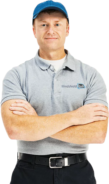 A person wearing a blue cap and a grey polo shirt with the logo Windshield Hub. The individual is posing with their arms crossed, sporting a confident and friendly expression. The background is transparent. 